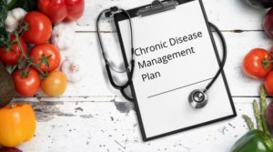 chronic disease management plan document on table with produce and stethoscope
