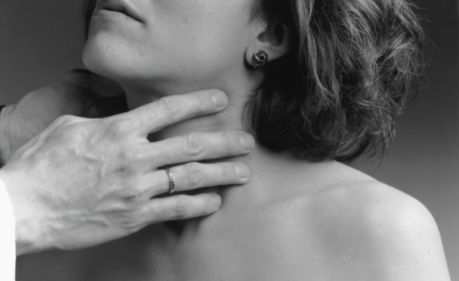 thyroid symptoms doctor checking throat of woman